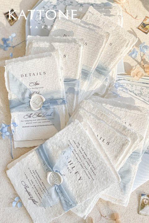 Collection of wedding invitations and stationery items, assembled with silk ribbons and wax seals. envelope liners. Elevate your special day with our Briseis Handmade Paper Wedding Invites. Crafted with love and attention to detail, these elegant invitations blend rustic charm with modern design. Each piece is made from eco-friendly materials, ensuring a unique touch for your celebration. Perfect for intimate gatherings or grand affairs, our invites set the tone for your wedding. 