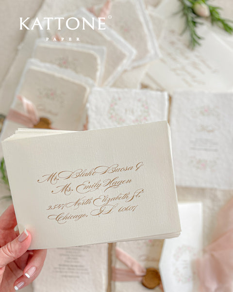 Announce your special day with the delicate, romantic charm of these handmade wedding invites. Perfect for a summer wedding, this suite features a soft and beautiful dusty pink color palette and delicate floral artwork. Each invitation is individually crafted, giving it a unique, tactile feel that you and your guests will appreciate. The combination of handcrafted artistry and a fresh, romantic design sets a beautiful tone for your celebration.