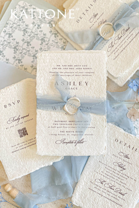 Collection of wedding invitations and stationery items, assembled with silk ribbons and wax seals. envelope liners. Elevate your special day with our Briseis Handmade Paper Wedding Invites. Crafted with love and attention to detail, these elegant invitations blend rustic charm with modern design. Each piece is made from eco-friendly materials, ensuring a unique touch for your celebration. Perfect for intimate gatherings or grand affairs, our invites set the tone for your wedding. 