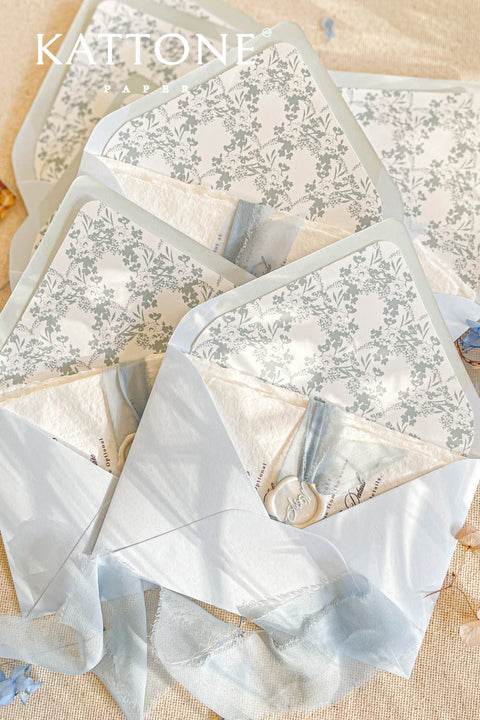 Collection of wedding invitations and stationery items, assembled with silk ribbons and wax seals. envelope liners. Elevate your special day with our Briseis Handmade Paper Wedding Invites. Crafted with love and attention to detail, these elegant invitations blend rustic charm with modern design. Each piece is made from eco-friendly materials, ensuring a unique touch for your celebration. Perfect for intimate gatherings or grand affairs, our invites set the tone for your wedding. 