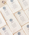 Elevate your wedding décor with our botanical handmade paper table numbers, crafted on deckle-edged cotton paper and printed with delicate floral-inspired typography. Each piece is adorned with subtle botanical detailing, creating a natural, organic aesthetic perfect for garden weddings, rustic themes, or fine-art celebrations. These table numbers add refined charm to any reception setting, offering both beauty and functionality.