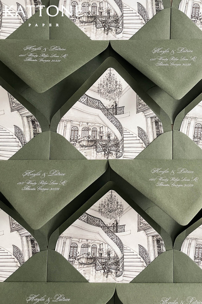 Luxury hunter green wedding envelopes with custom architectural venue liners featuring elegant interior sketch artwork in monochrome tones.