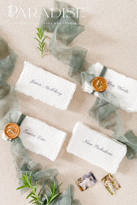 Enhance your tablescape with our handmade paper place cards, crafted from luxurious cotton rag paper and finished with naturally torn deckled edges. Each card features elegant calligraphy, soft hand-dyed ribbon, and the option of a wax seal for added fine-art charm. Perfect for weddings, engagement parties, showers, and upscale events, these artisanal place cards bring texture, romance, and sophistication to every setting.