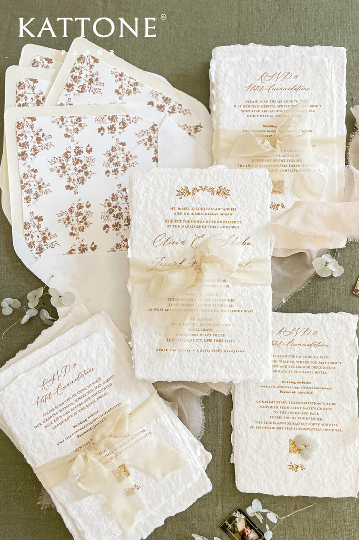 Handmade cotton paper wedding invitation suite with deckled edges, sepia floral design, sheer ivory silk ribbon and coordinated botanical envelope liners.