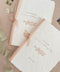 Handmade wedding programs with deckled edges, blush silk ribbon binding and floral illustration on cotton paper.