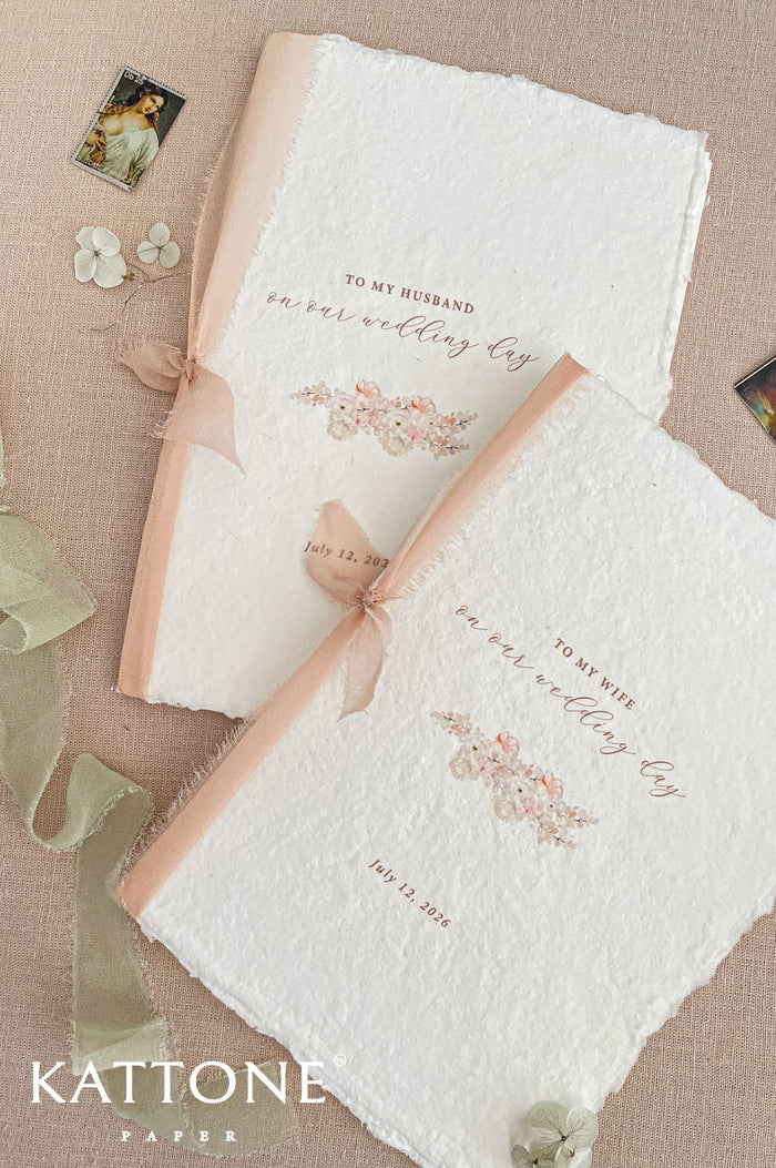 Handmade wedding programs with deckled edges, blush silk ribbon binding and floral illustration on cotton paper.