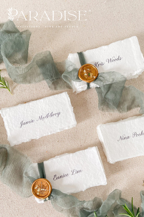 Enhance your tablescape with our handmade paper place cards, crafted from luxurious cotton rag paper and finished with naturally torn deckled edges. Each card features elegant calligraphy, soft hand-dyed ribbon, and the option of a wax seal for added fine-art charm. Perfect for weddings, engagement parties, showers, and upscale events, these artisanal place cards bring texture, romance, and sophistication to every setting.