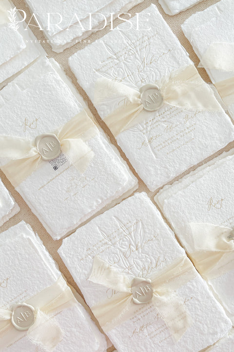 This exquisite wedding invites suite offers a blend of natural elegance and modern sophistication. Printed on luxurious handmade cotton paper in a soft ivory hue, each invitation features a delicate blind embossed floral design. A touch of refined artistry is added with elegant modern calligraphy, creating a truly classy wedding stationery set that beautifully hints at your special day.