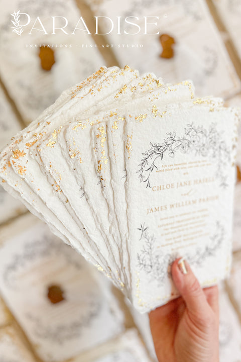 This exquisite wedding invitations suite offers a blend of natural texture and timeless charm. Each invite is printed on luxurious handmade paper with a delicate deckle edge, providing a rich, organic feel. The design is finished with a delicate golden leaf detail, adding a touch of understated elegance and luxury. The result is a truly memorable vintage style stationery set that beautifully hints at your special day.