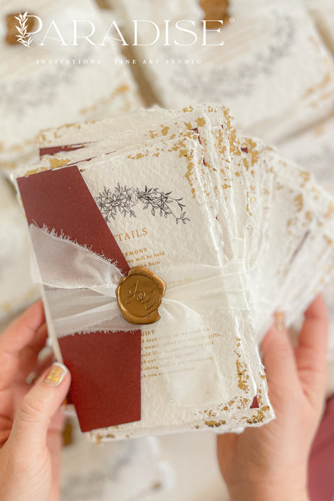 This exquisite wedding invitations suite offers a blend of natural texture and timeless charm. Each invite is printed on luxurious handmade paper with a delicate deckle edge, providing a rich, organic feel. The design is finished with a delicate golden leaf detail, adding a touch of understated elegance and luxury. The result is a truly memorable vintage style stationery set that beautifully hints at your special day.