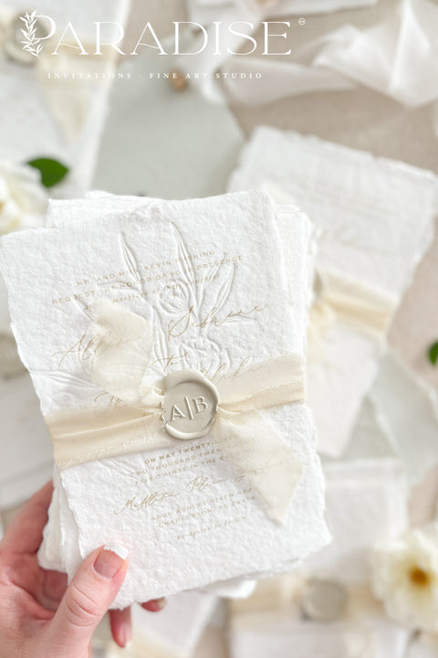 This exquisite wedding invites suite offers a blend of natural elegance and modern sophistication. Printed on luxurious handmade cotton paper in a soft ivory hue, each invitation features a delicate blind embossed floral design. A touch of refined artistry is added with elegant modern calligraphy, creating a truly classy wedding stationery set that beautifully hints at your special day.
