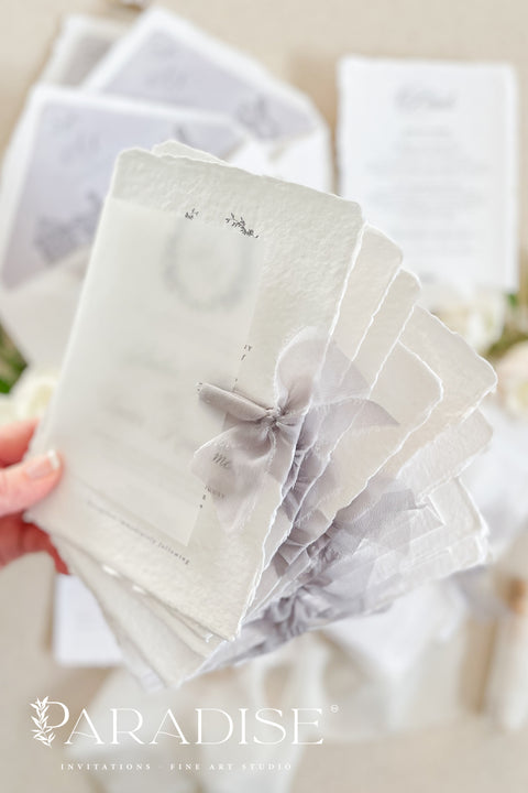 Announce your wedding with timeless elegance through our handmade deckled-edge wedding invitations, designed for couples who appreciate artistry, detail, and refinement. Crafted from 100% cotton paper with hand-torn edges, each invitation features soft grey typography, a vellum overlay, and a silk ribbon tie exuding understated luxury. Perfect for fine art, garden, estate, or destination weddings.