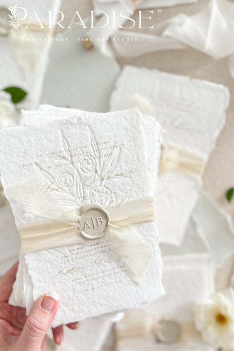 This exquisite wedding invites suite offers a blend of natural elegance and modern sophistication. Printed on luxurious handmade cotton paper in a soft ivory hue, each invitation features a delicate blind embossed floral design. A touch of refined artistry is added with elegant modern calligraphy, creating a truly classy wedding stationery set that beautifully hints at your special day.