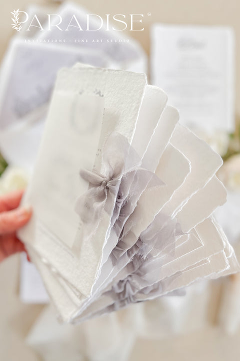 Announce your wedding with timeless elegance through our handmade deckled-edge wedding invitations, designed for couples who appreciate artistry, detail, and refinement. Crafted from 100% cotton paper with hand-torn edges, each invitation features soft grey typography, a vellum overlay, and a silk ribbon tie exuding understated luxury. Perfect for fine art, garden, estate, or destination weddings.