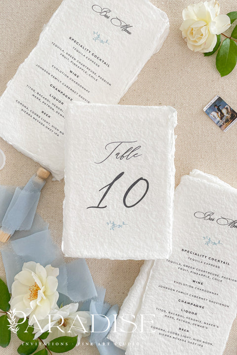 These fine-art handmade paper table numbers bring a soft, romantic touch to your wedding tablescape.&nbsp;Artisan cotton paper, natural deckled edges, and minimalist lettering create a timeless look that elevates every reception setting. Each piece is individually crafted, giving your décor a refined, organic feel that photographs beautifully and enhances your event's overall aesthetic. Perfect for classic, coastal, garden, or luxury celebrations.