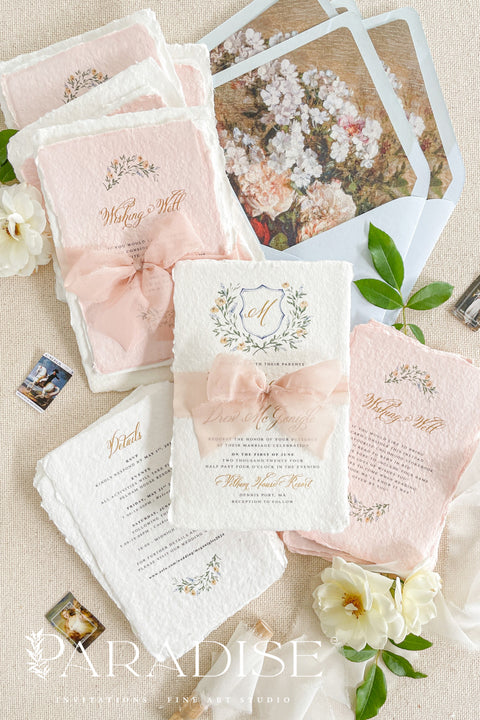 Announce your love story with timeless artistry through our handmade watercolor floral crest wedding invitations, where classic design meets modern elegance. Each invitation is crafted by hand and features a beautifully painted watercolor crest of delicate florals, personalized with your initials - a true symbol of your union.