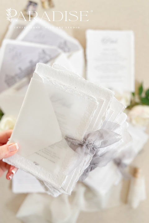 Announce your wedding with timeless elegance through our handmade deckled-edge wedding invitations, designed for couples who appreciate artistry, detail, and refinement. Crafted from 100% cotton paper with hand-torn edges, each invitation features soft grey typography, a vellum overlay, and a silk ribbon tie exuding understated luxury. Perfect for fine art, garden, estate, or destination weddings.