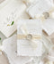 This exquisite wedding invites suite offers a blend of natural elegance and modern sophistication. Printed on luxurious handmade cotton paper in a soft ivory hue, each invitation features a delicate blind embossed floral design. A touch of refined artistry is added with elegant modern calligraphy, creating a truly classy wedding stationery set that beautifully hints at your special day.