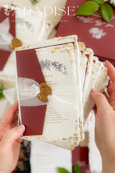 This exquisite wedding invitations suite offers a blend of natural texture and timeless charm. Each invite is printed on luxurious handmade paper with a delicate deckle edge, providing a rich, organic feel. The design is finished with a delicate golden leaf detail, adding a touch of understated elegance and luxury. The result is a truly memorable vintage style stationery set that beautifully hints at your special day.