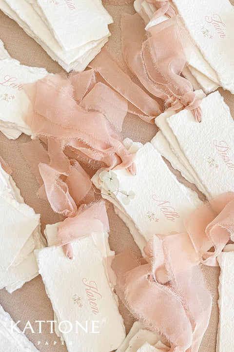 Stack of personalized place cards showcasing consistent design and handcrafted finish.