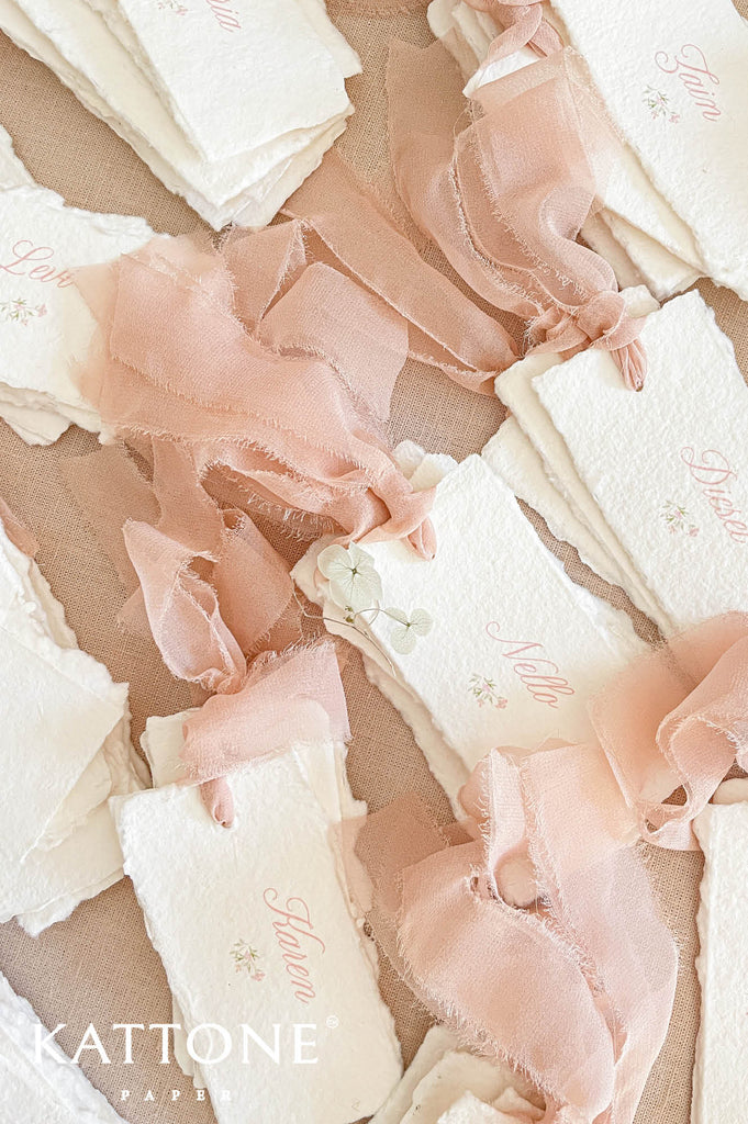 Stack of personalized place cards showcasing consistent design and handcrafted finish.