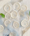 Hand-poured wax seals designed to add a soft, romantic finish to wedding stationery, envelopes, and heirloom keepsakes. Featuring an intricate floral crest pressed into creamy white wax, each seal offers timeless elegance with a tactile, artisanal feel. Perfect for couples seeking refined details that elevate their invitations, vows, or correspondence into something truly memorable.