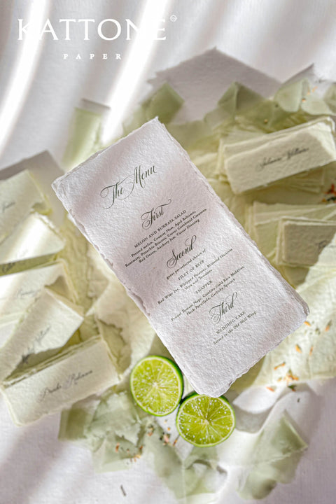 These handmade paper wedding menus are a true expression of understated luxury and timeless romance. Meticulously crafted from 100% cotton rag paper, each menu features naturally deckled edges that reflect the artistry of traditional papermaking. The soft, tactile texture pairs beautifully with classic calligraphy-inspired typography, evoking an old-world charm that feels both intimate and refined.