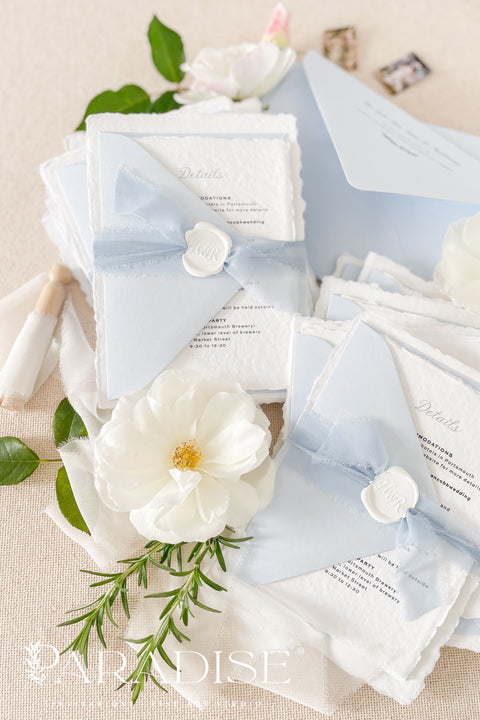 Delicate, refined, and beautifully personal - our handmade wedding invitations with a monogram crest are designed to capture the essence of timeless romance. Printed on luxury cotton paper with soft deckled edges, made entirely by hand and tied with a light blue silk ribbon for a graceful finishing touch. The custom monogram crest adds an elegant and personal element, making every suite unique to you and your story.