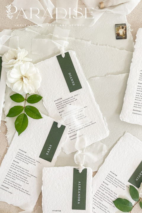 Refined, timeless, and effortlessly elegant - our handmade paper wedding menus are the perfect addition to any fine art table setting. Each menu is crafted from 100% cotton rag paper, featuring soft deckled edges and a personalized name tag in deep forest green tones for a modern botanical touch. Finished with delicate silk ribbon detailing, these menus bring sophistication and cohesion to your event design.