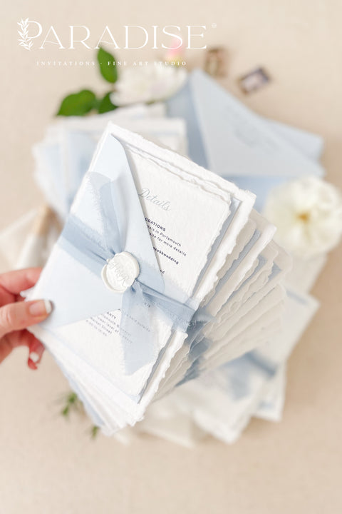 Delicate, refined, and beautifully personal - our handmade wedding invitations with a monogram crest are designed to capture the essence of timeless romance. Printed on luxury cotton paper with soft deckled edges, made entirely by hand and tied with a light blue silk ribbon for a graceful finishing touch. The custom monogram crest adds an elegant and personal element, making every suite unique to you and your story.