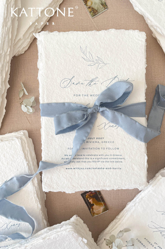 Fine art wedding stationery styled with handmade save the date cards, silk ribbon, neutral fabric and dried floral elements.
