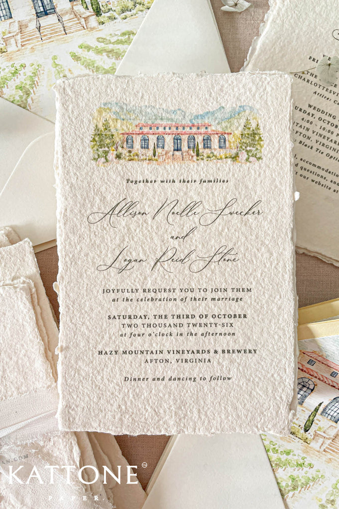 Wedding stationery arranged in a luxury flat lay showcasing handmade paper invitations, vellum jacket, envelope liners, wax seal, ribbon, and coordinated insert cards.