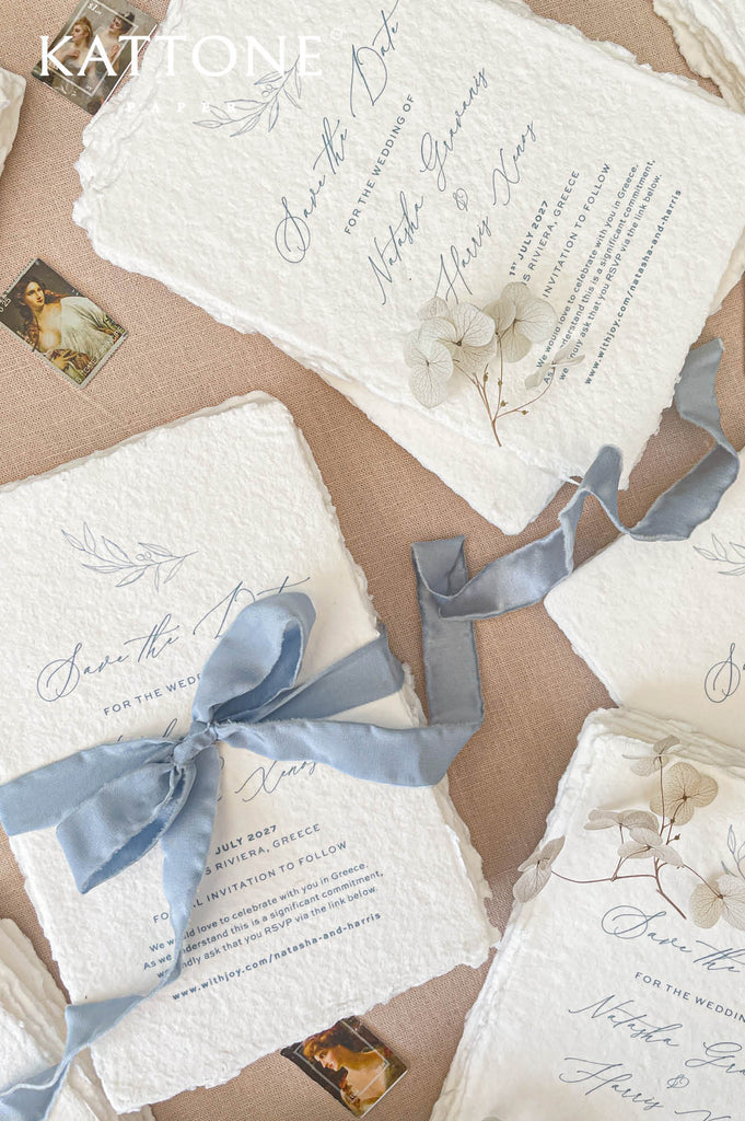Minimalist leaf illustration printed in soft blue ink on handmade cotton paper adding subtle decorative detail.