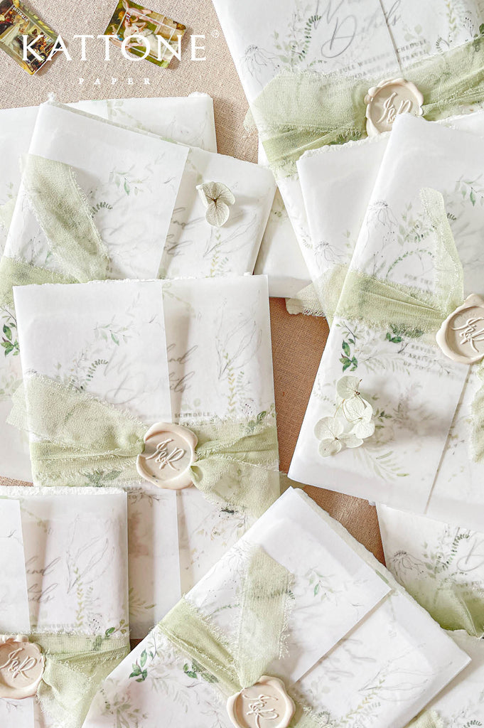 Soft translucent vellum jacket layered over the invitation creates a romantic and sophisticated presentation with subtle depth.