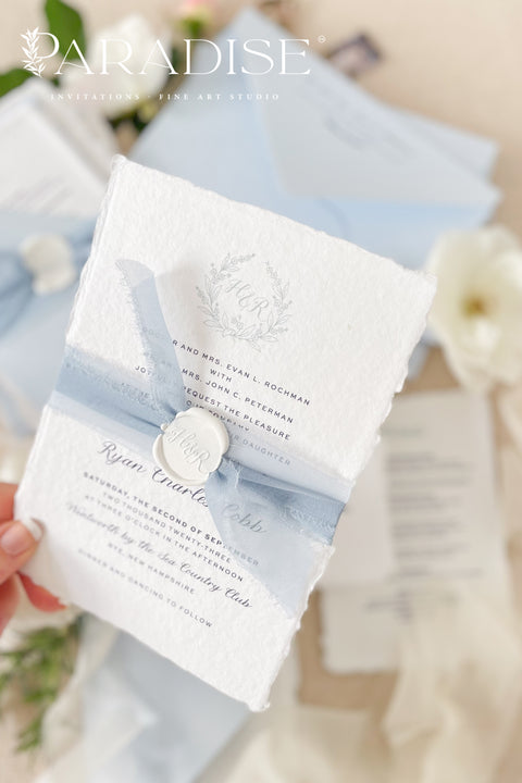 Delicate, refined, and beautifully personal - our handmade wedding invitations with a monogram crest are designed to capture the essence of timeless romance. Printed on luxury cotton paper with soft deckled edges, made entirely by hand and tied with a light blue silk ribbon for a graceful finishing touch. The custom monogram crest adds an elegant and personal element, making every suite unique to you and your story.