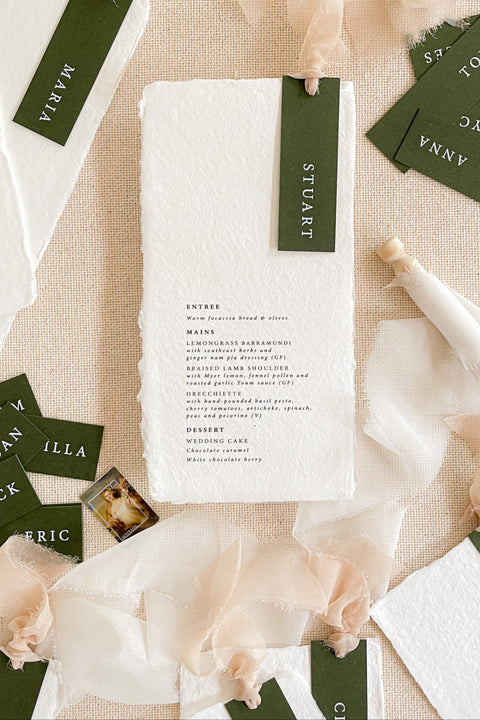 Make every seat a statement with our handmade paper wedding menus, featuring personalized name tags, soft ribbons, and deckled edges. Each menu is crafted on luxury cotton rag paper for a fine art look that’s both organic and sophisticated - ideal for modern, romantic, or nature-inspired weddings. Thoughtfully designed to blend function and beauty, these menus elevate your reception with artisanal charm and timeless elegance.
