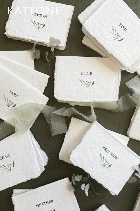 Stack of personalized place cards showcasing consistent design and handcrafted quality.