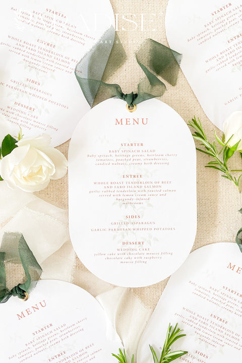 Make a refined statement at your reception with our double arch wedding menus, a modern take on classic elegance. These menus feature a unique double-arched silhouette, expertly printed on luxury thick cardstock for a soft yet structured feel. The minimalist layout highlights elegant typography in warm, contemporary tones, while a silk chiffon ribbon and gold grommet detail add a sophisticated finishing touch.