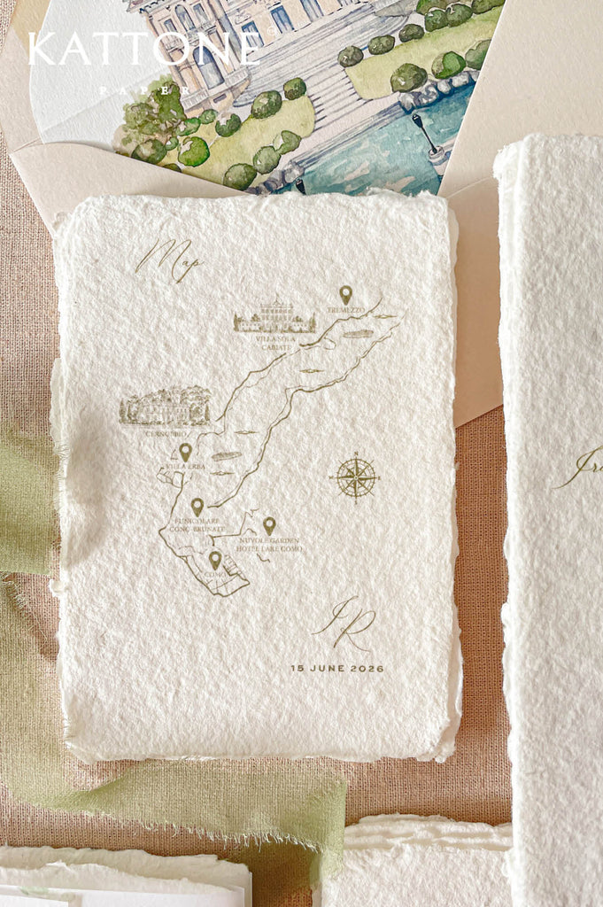 Handmade paper wedding map card featuring custom illustrated travel route details with delicate gold accents and refined typography.