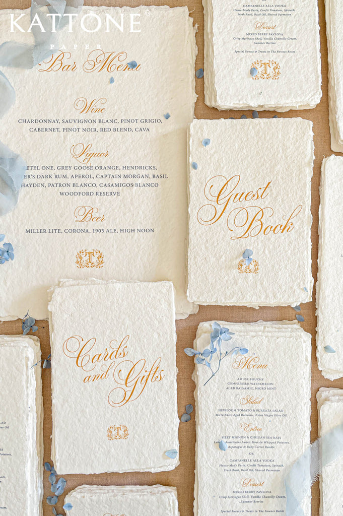 Elegant handmade paper wedding menu featuring classic course layout, refined typography, and naturally deckled edges for a luxury tablescape.