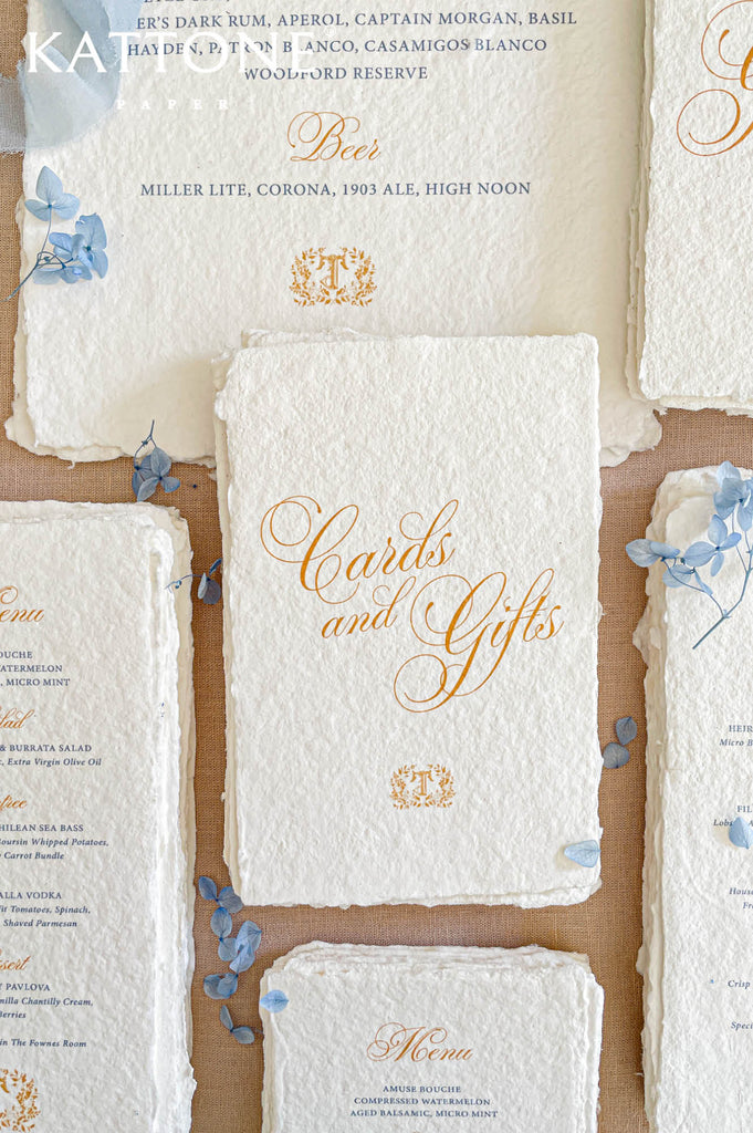 Luxury wedding menu stationery featuring gold script headings paired with refined blue serif typography for timeless sophistication.