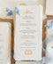 Luxury handmade paper wedding menus featuring deckled edge cotton paper, elegant gold script headings, blue typography, and delicate floral styling.