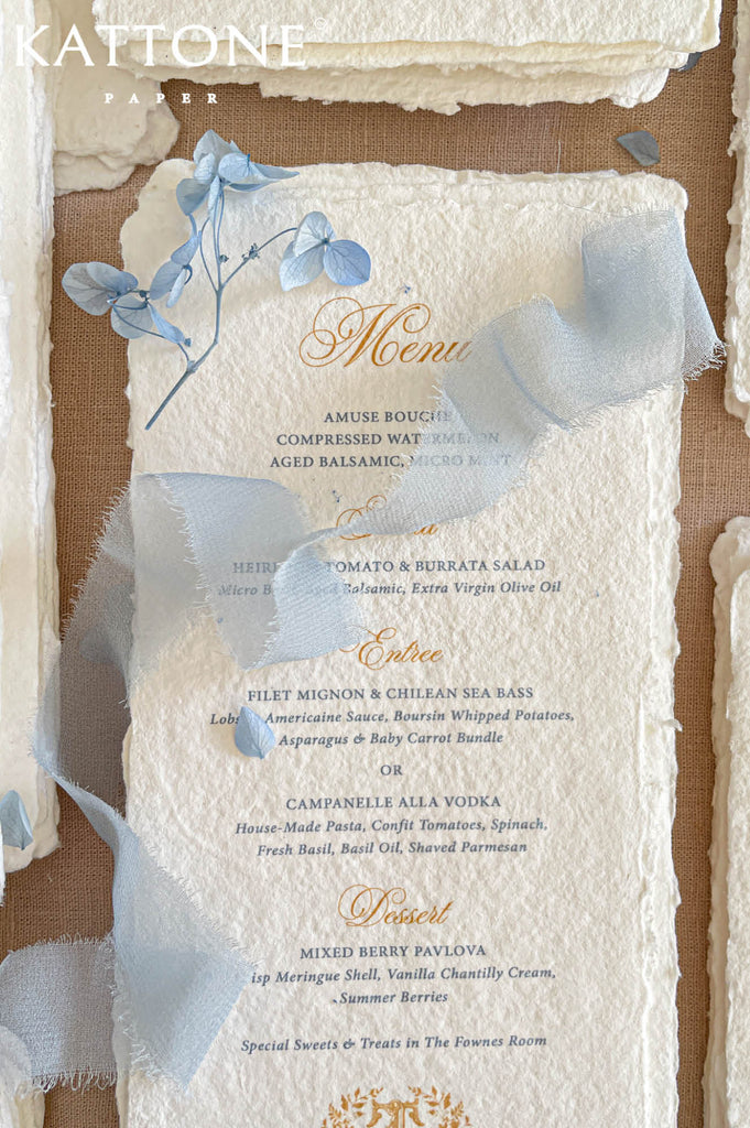 Elegant handmade paper wedding menu featuring classic course layout, refined typography, and naturally deckled edges for a luxury tablescape.