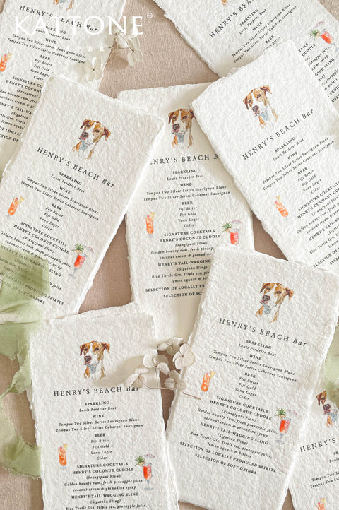 Handmade cotton paper wedding bar menus with deckled edges, featuring custom pet illustration and hand-painted cocktail icons.