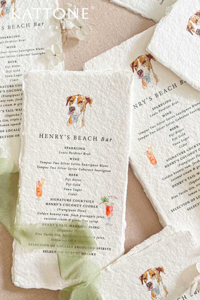 Fine art bar menu suite styled in flat lay with multiple handmade paper menus, soft fabric and floral accents.