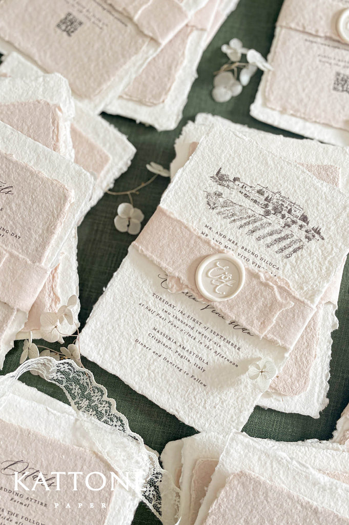 Close up of textured handmade cotton paper invitation highlighting deckled edges, fine architectural illustration and elegant typography.