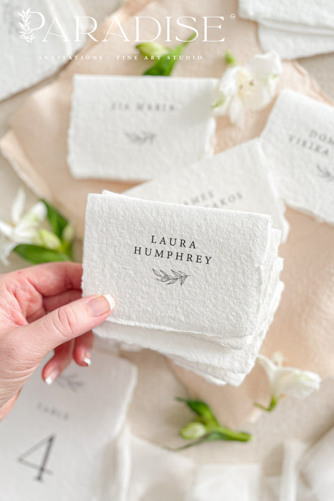 Elevate your event with our handmade paper place cards, crafted from luxurious cotton rag paper and finished with naturally torn deckled edges. Each card features minimalist typography paired with a delicate botanical illustration, creating a refined fine-art look perfect for weddings, rehearsal dinners, and intimate celebrations. These artisan-crafted place cards bring organic texture, timeless elegance, and a soft romantic touch to any tablescape.