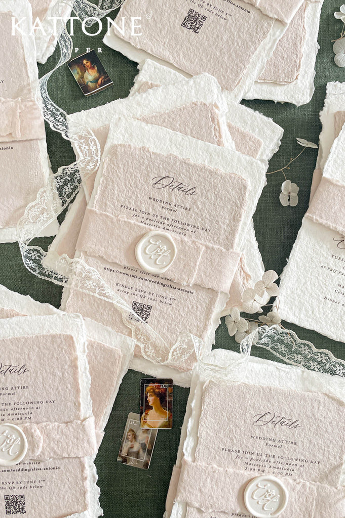 Soft blush handmade paper inserts with printed details and QR code, adding depth and layered styling.