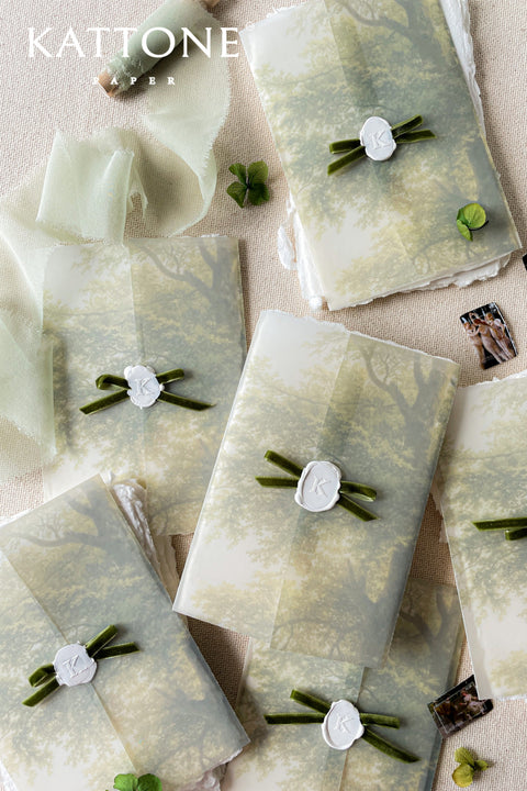 Vellum jackets and white wax seals with velvet ribbons
