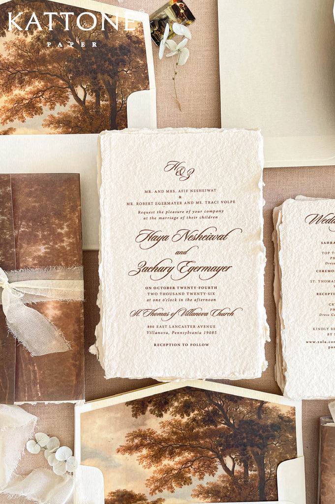 Premium handmade paper wedding invitation suite with custom scenic artwork, vellum wraps, deckled edge cotton paper, and elegant calligraphy for romantic luxury weddings.